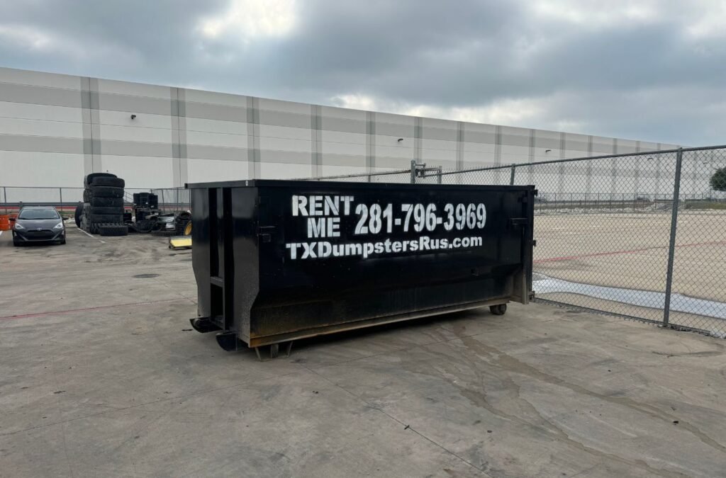 TX Dumpsters R Us employee delivering a commercial dumpster in Lancaster, TX.