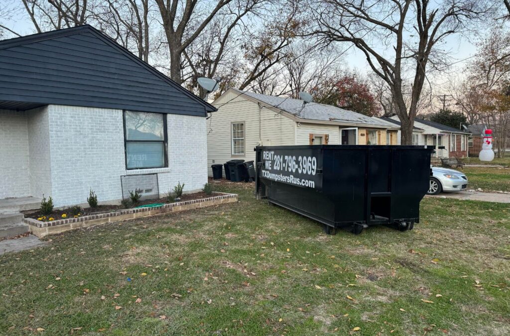 TX Dumpsters R Us employee delivering a residential dumpster in Lancaster, TX.